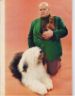 Bald Handler in a very 1970s green sport jacket holding a chijuajua.  Lying on the ground is the champion Old English Sheepdog Sir Lancelot of Barvan.