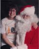 Grannie Annie Raker, Placement Director for New England Old English Sheepdog Rescue, Inc. is Sitting on Santas lap.  Both are laughing.